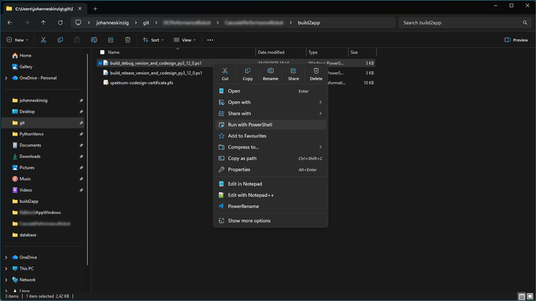 Windows Explorer showing the 'build2app' folder with context menu over the PowerShell script.